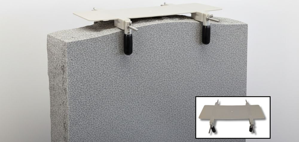 Sure-Fit saddle frame hardware showing metal brackets and clips for securing floral arrangements to monument headstones