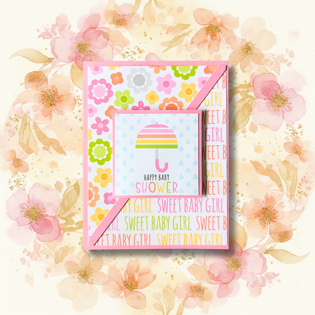 Handmade happy baby shower sweet baby girl greeting card with striped umbrella and colourful patterned papers on pink floral background