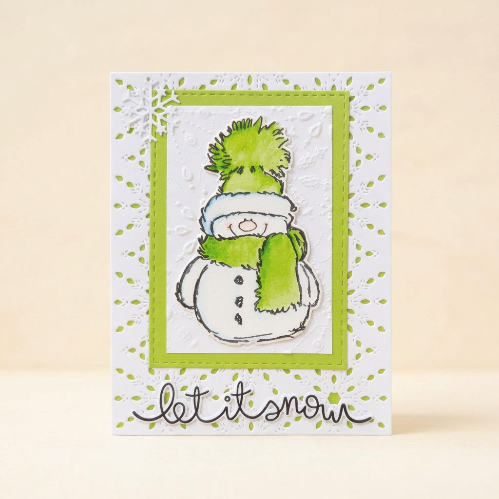 Green snowman Let It Snow greeting card with embossed white layers and snowflake details on a cream background.